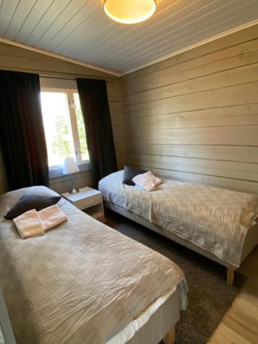 Postel nebo postele na pokoji v ubytování Oravanpesä