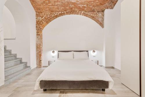 En eller flere senge i et værelse på Mole Luxury Suite Torino