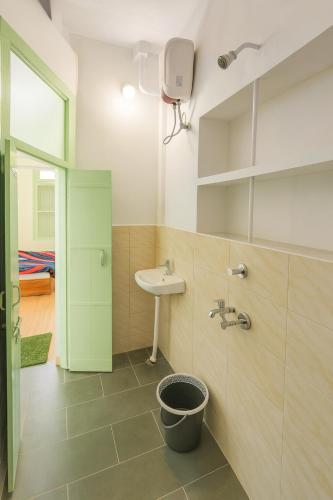 a small bathroom with a sink and a toilet at Johari Heritage Home in Ujjain