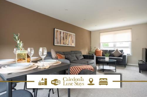 a living room with a couch and a table with wine glasses at Rise House in Livingston