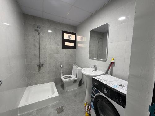 a bathroom with a sink and a toilet and a tub at Al Karama Studio in Abu Dhabi