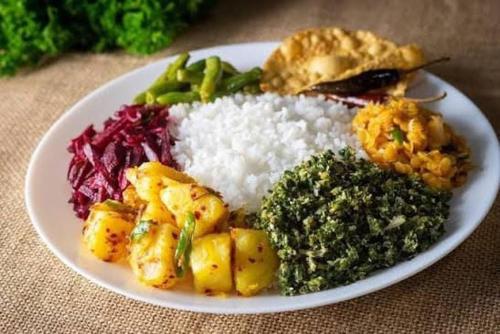 a plate of food with rice and vegetables on a table at Yala Eagle Nest in Tissamaharama
