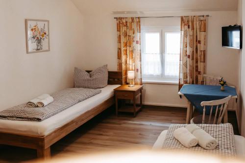 a small room with two beds and a window at Pension Adler in Sonthofen