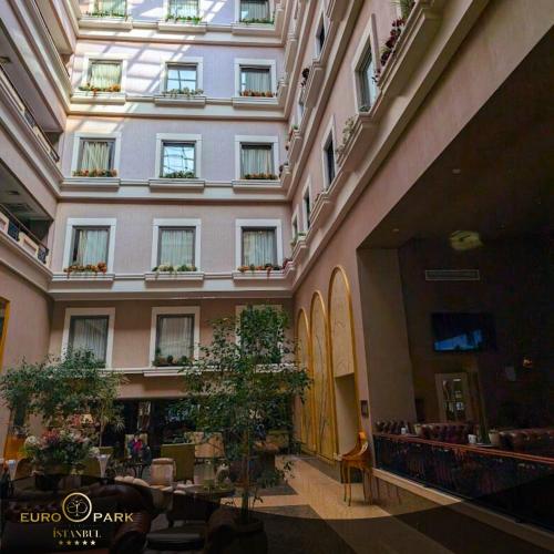a large building with windows and plants in a hallway at Euro Park Otel in Istanbul