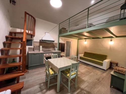 a kitchen with a table and a couch in a room at Casetta Margherita in Bisceglie