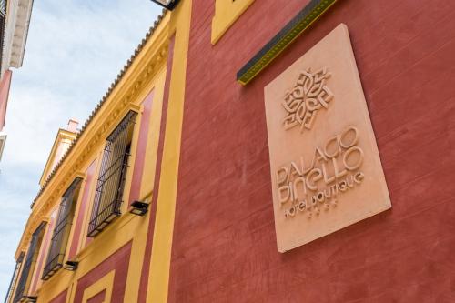 a building with a sign on the side of it at Palacio Pinello in Seville