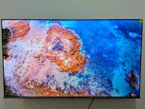 a flat screen tv sitting on top of a wall at Hotel-Style 1BR Near Mall of Oman in Muscat