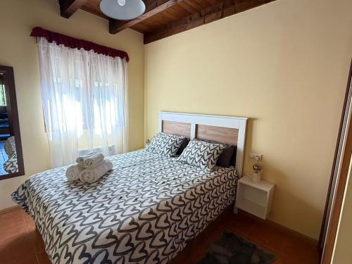 a bedroom with a bed with a teddy bear on it at Villa Quijada in Trefacio