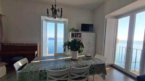 a dining room with a table and views of the ocean at Casa Gargano Ravello Amalfi Coast in Amalfi