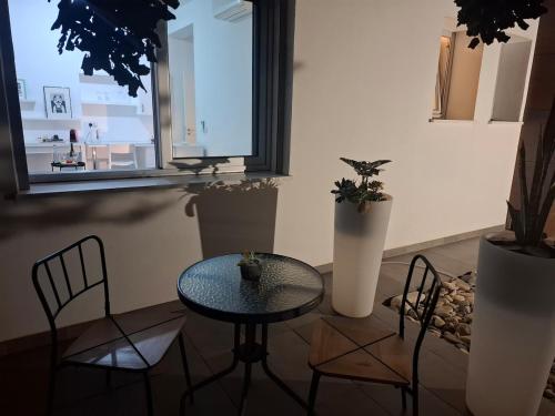a table and chairs in a room with a window at Cozy studio! in Paphos City