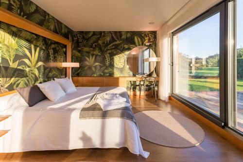 a bedroom with a bed and a large window at Villa Monasterio in Escobedo