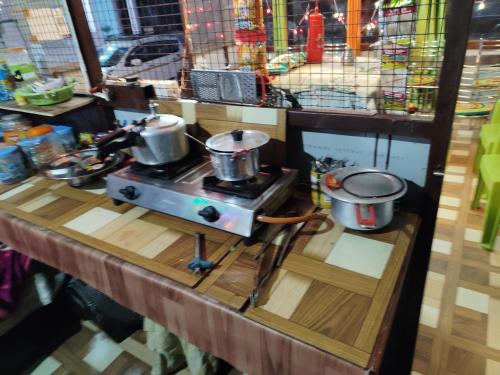 Eine Arbeitsfläche mit zwei Töpfen auf einem Herd in der Unterkunft Shri Ganesh Home stay in Ukhimath