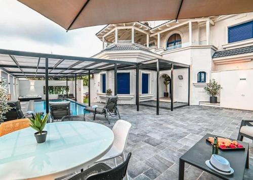 patio ze stołem i krzesłami w obiekcie אחוזת סנטוריני - וילה מהממת עם בריכה מחוממת מקורה וג'קוזי בעין יעקב w mieście ‘Ein Ya‘aqov