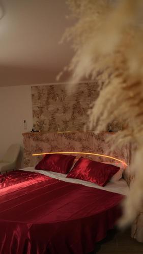 a bedroom with a red bed with red pillows at Monte d'Oro Rooms in Scauri