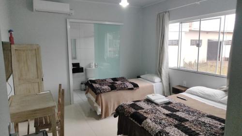 Ένα ή περισσότερα κρεβάτια σε δωμάτιο στο Hotel Guarany