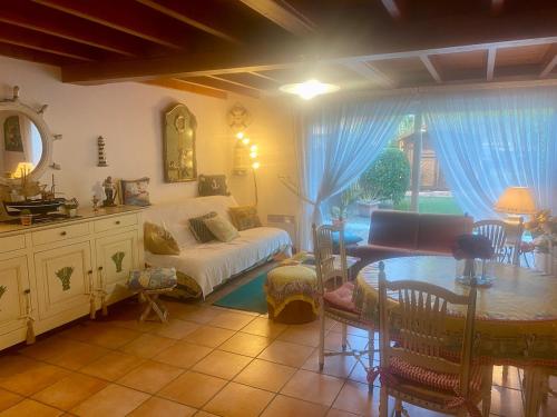 a living room with a couch and a table at Au Petit Bonheur in Cucq