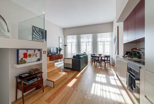 a living room with a couch and a table at Art Living Estação by Home Sweet Home Aveiro in Aveiro