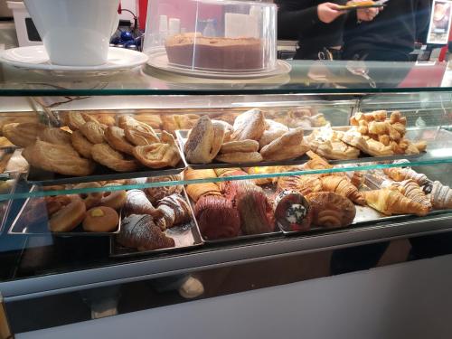 a display case filled with lots of different types of pastries at B&B metro B fronte metro in Rome