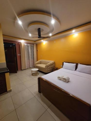 a bedroom with a large bed and a couch at Seko Haven Resort in Kilifi