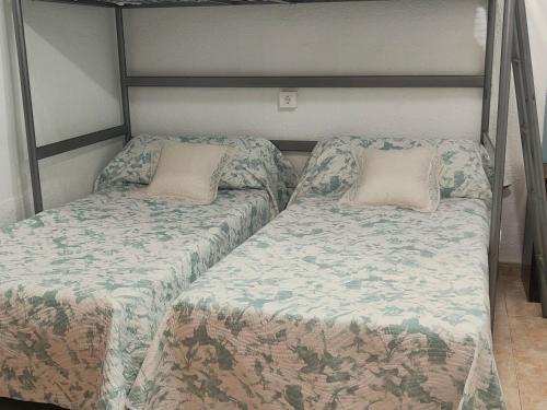 a bunk bed with two pillows on top of it at La Parrita in Guadalcanal