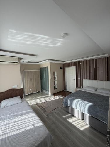 a bedroom with a large bed and a couch at Birds inn in Kuşadası