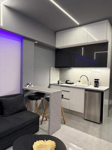 a kitchen and living room with a table and a couch at Crystal Grey Elite Apartment 2 in Serres