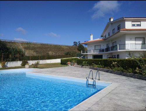 a swimming pool in front of a house at Vergikosk House - villa 4 quartos com piscina privada in Bombarral