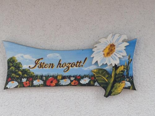 a sign on a wall with a flower on it at Bornemisza Kuria in Tiszabecs
