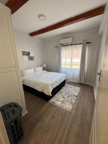 a bedroom with a bed and a window at The Vantage in Lusaka