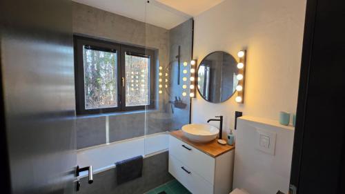 a bathroom with a sink and a mirror at Dachstein104 in Bad Goisern