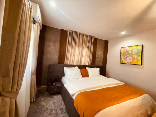 a bedroom with a large bed in a room at TGH Gracies Hotel in Port Harcourt