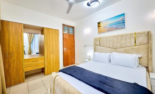 a bedroom with a large bed and a window at Diani beachview escape in Ukunda