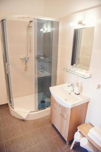 a bathroom with a shower and a sink at Penzion Albrechtt in Kežmarok