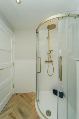 a shower with a glass door in a bathroom at Eagleside Apartments in Auchterarder
