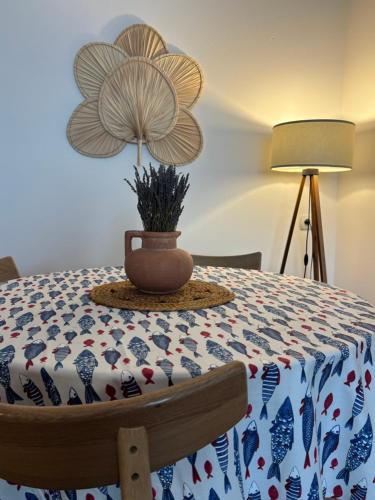 a table with a flower on it with a plant on it at Flora Apartment - near the sea in Bar, Susanj