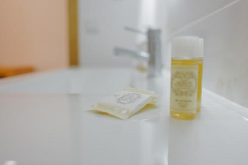 a bottle of soap and a book on a counter at Coração de Viana AL in Viana do Castelo