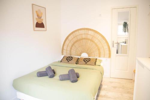 a bedroom with a bed with two pillows on it at Charmant Studio avec parking Résidence Zénith in Caen