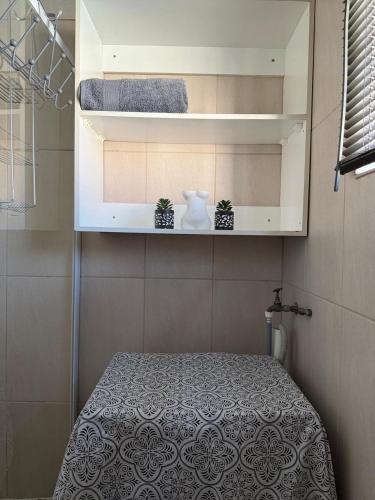 a small room with a bed with two plants in it at 4 On Susanna in Kimberley