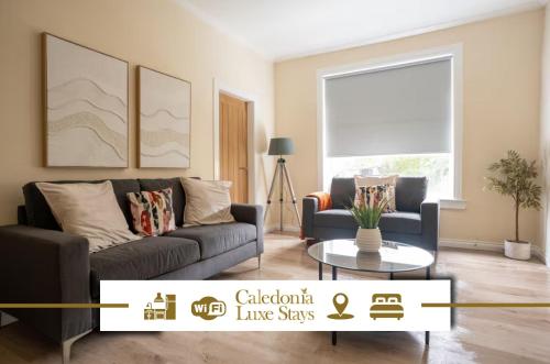 a living room with a couch and a table at Curtis Apartment in Glasgow