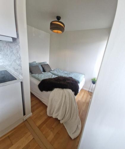 a bedroom with a bed with a blanket on it at Modern condominium in Bergen