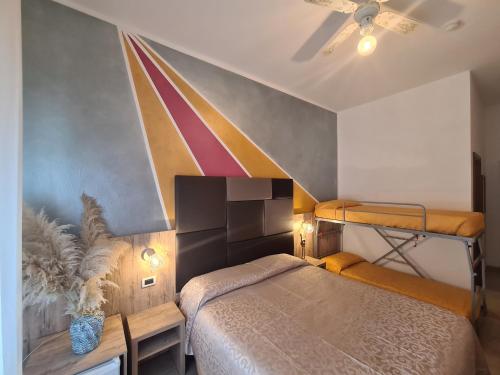 a bedroom with two bunk beds and a ceiling at Hotel Gladys in Cesenatico