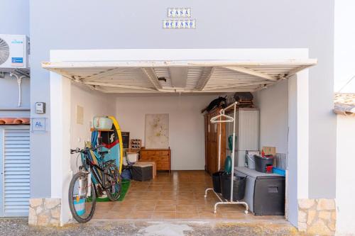 a room with a bike parked under a garage at Casa Oceano-Mar a vista in Raposeira