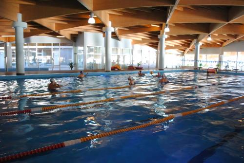 Beachfront Central Apartments في دوريس: مجموعة من الأشخاص في حمام السباحة