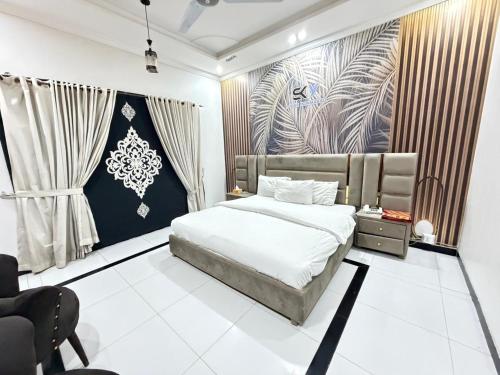 a bedroom with a bed and a painting on the wall at Sky Lodge Guest House in Islamabad