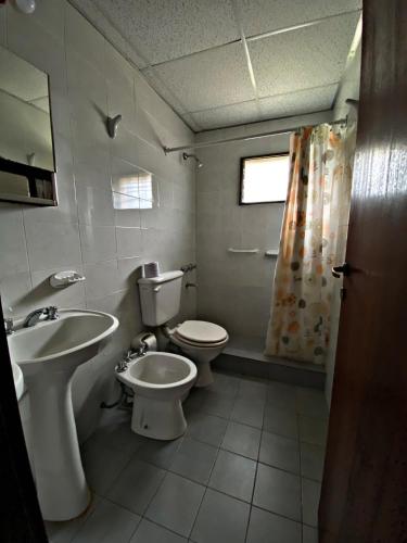 a bathroom with a toilet and a sink at Altos del Rincón in Merlo