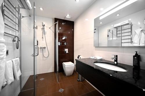 a bathroom with a sink and a shower and a toilet at Ararat Resort Tsaghkadzor in Tsaghkadzor