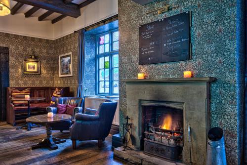 a room with a fireplace and a chalkboard on the wall at George of Piercebridge in Piercebridge