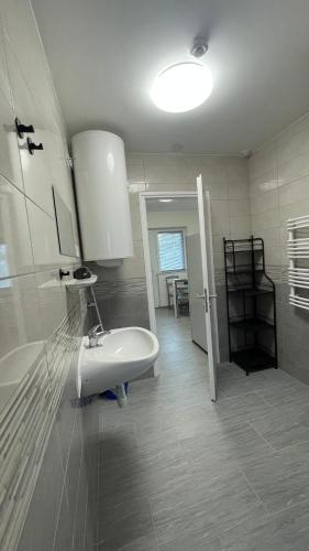 a white bathroom with a sink and a toilet at KULCSi SZÁLLÁS in Kulcspuszta