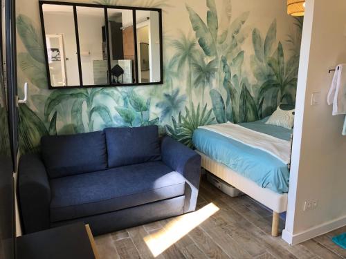 a living room with a couch and a mirror at Appart'Hotel au Pradet in Le Pradet