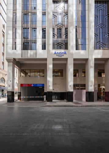 an empty parking lot in front of a building at Ancyra Hotel - By Continent - فندق انكيرا in Medina